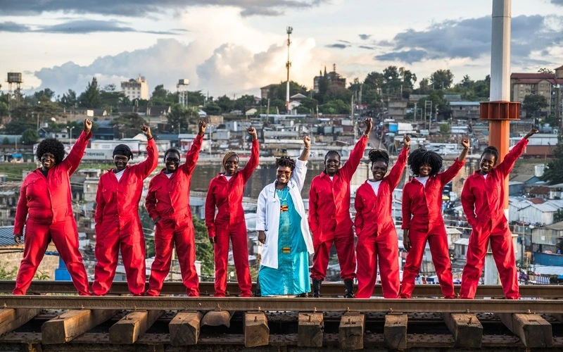 Dr. Stellah Bosire (middle) walks along the railroad tracks with the members of the Feminist for Peace, Rights, and Justice Center (FPRJC) in Kibera, Nairobi, Kenya.