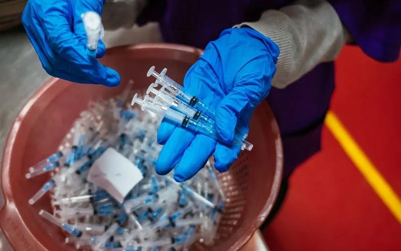 Faith Zighe checks to see if the syringes have been assembled correctly. She is one of the many hearing impaired workers at the Revital Healthcare factory in Kikambala, Kenya, on July 9, 2024.Revital Healthcare became the first East and Central African company to manufacture medical devices such as auto-disabled syringes and reuse-preventing syringes and has grown to become one of the largest manufacturers of medical disposable products in Africa.